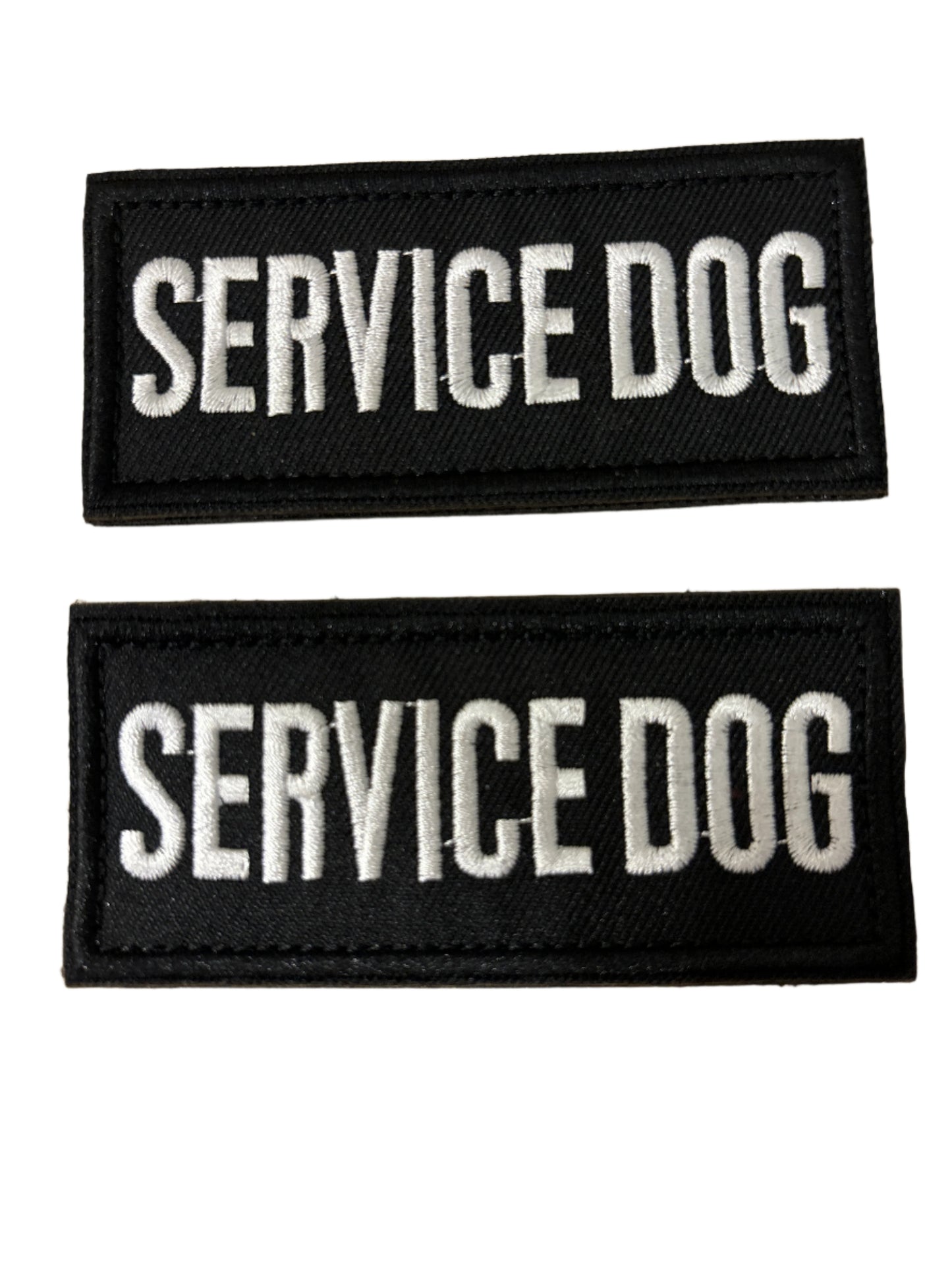 Two black 'SERVICE DOG' patches on a beige background