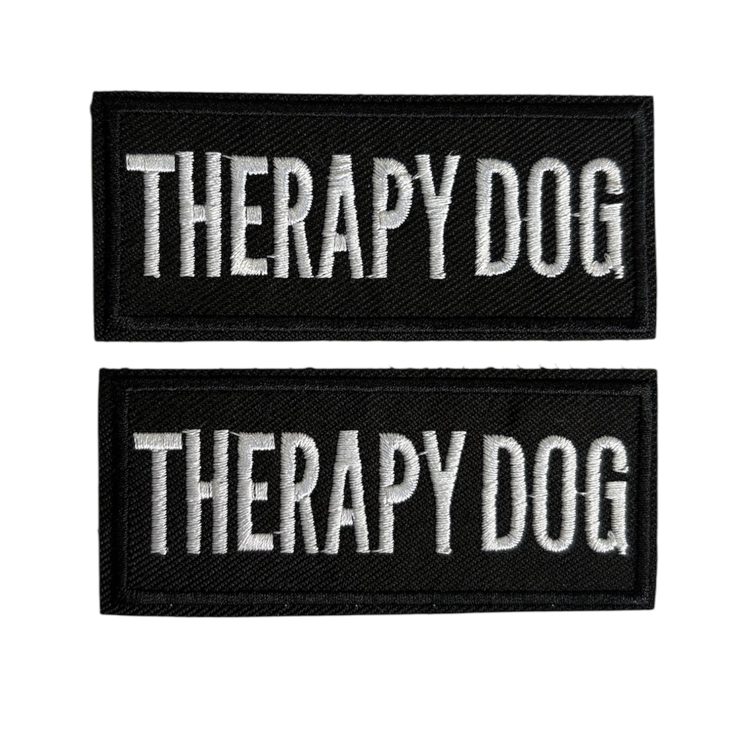 Two black patches with 'THERAPY DOG' text on a white background